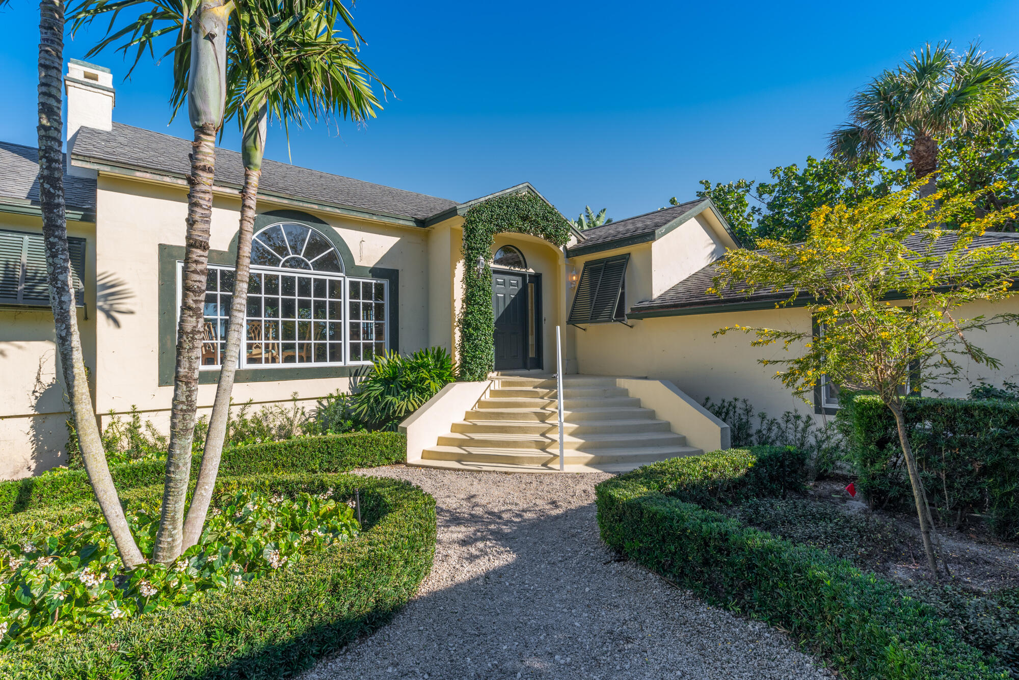 5 North Beach Road Hobe Sound, FL 33455 - Photo 6 of 26 a front view of a house with garden