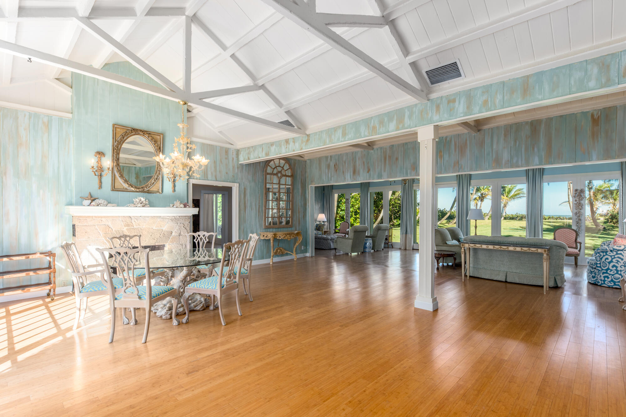 5 North Beach Road Hobe Sound, FL 33455 - Photo 8 of 26 a dining room with wooden floor a chandelier a glass table and chairs
