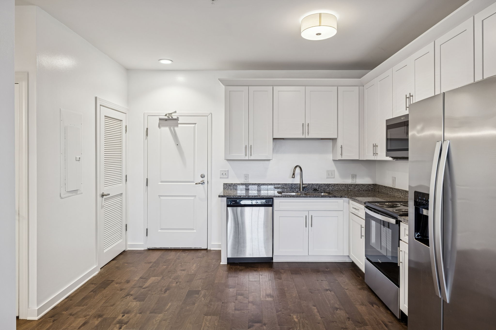 1319 West Main Street, Unit 104 Franklin, TN 37064 - Photo 4 of 20 a kitchen with stainless steel appliances and white cabinets