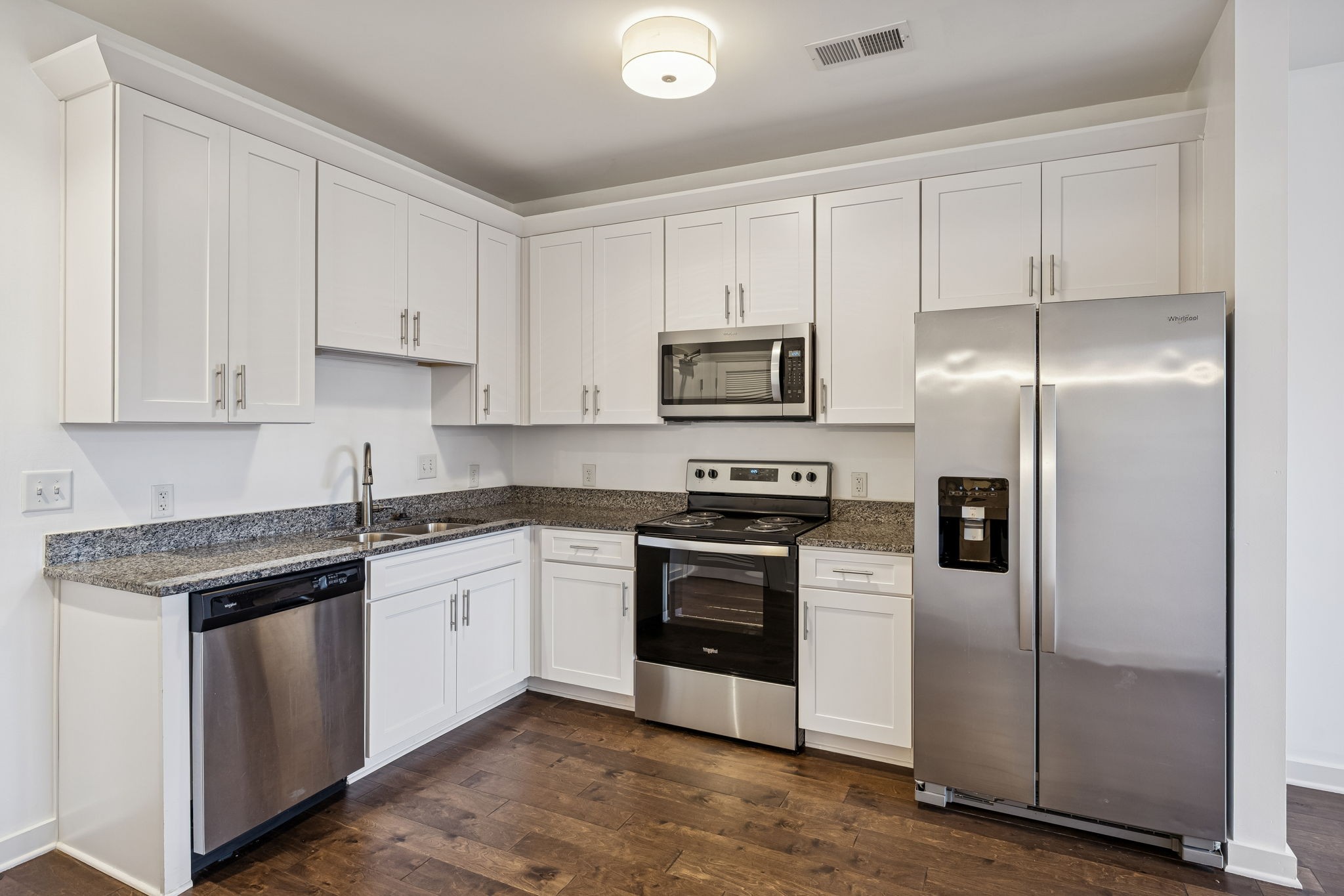 1319 West Main Street, Unit 104 Franklin, TN 37064 - Photo 5 of 20 a kitchen with cabinets stainless steel appliances and a counter space