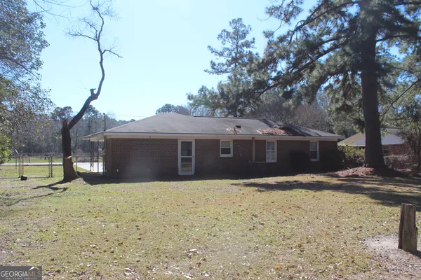 a house that has a tree in front of it