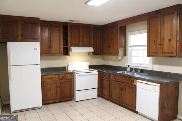 a kitchen with stainless steel appliances granite countertop a refrigerator sink and cabinets