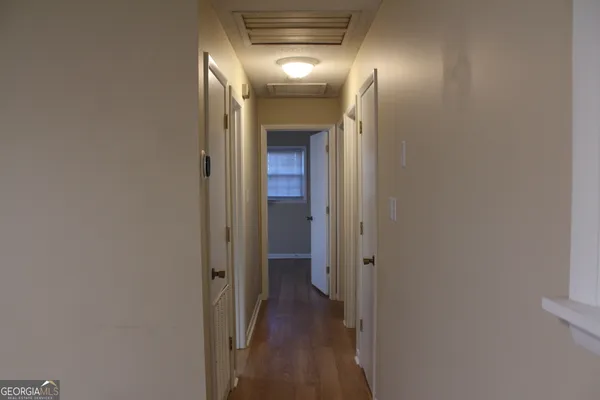 a view of hallway with wooden floor