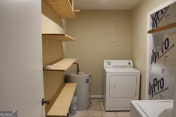 a bathroom with a sink and a washer dryer