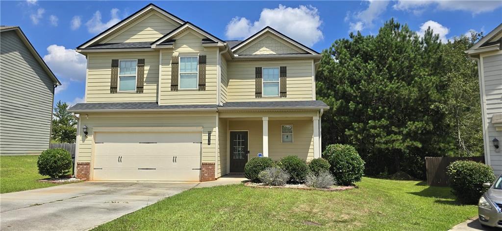 a front view of a house with a yard and garage