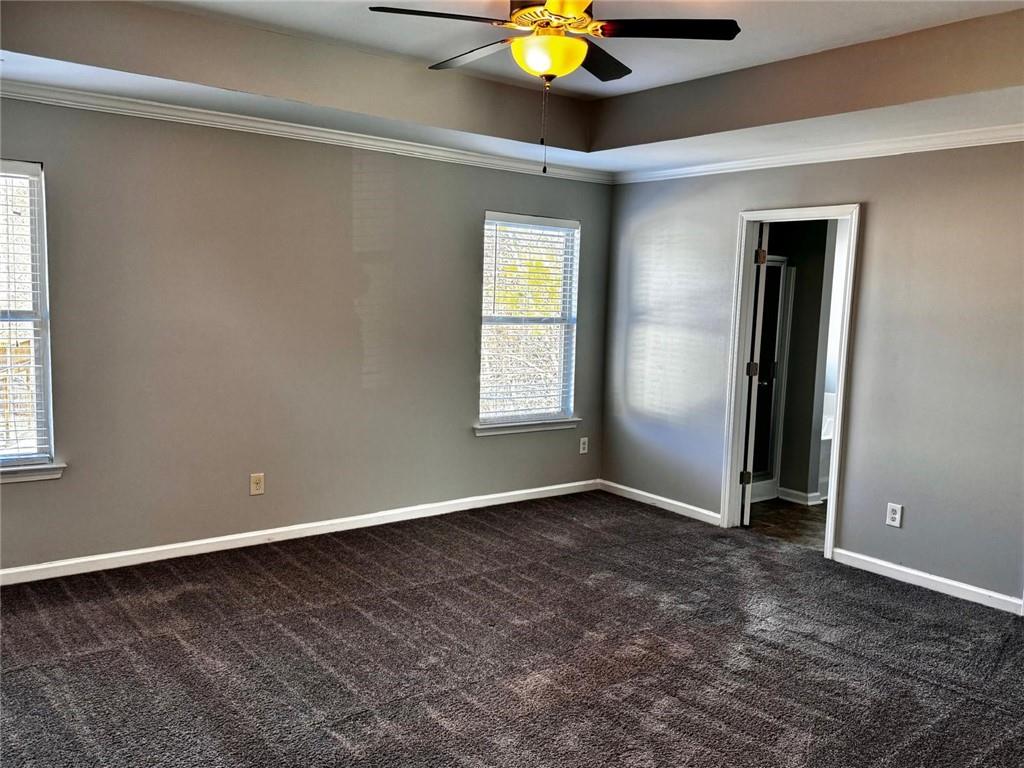 2230 Village Trail Court Dacula, GA 30019 - Photo 4 of 12 an empty room with window and chandelier fan