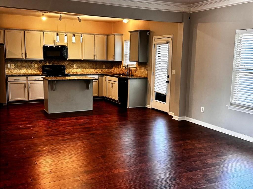 2230 Village Trail Court Dacula, GA 30019 - Photo 7 of 12 a kitchen with stainless steel appliances granite countertop a stove top oven a sink and a microwave