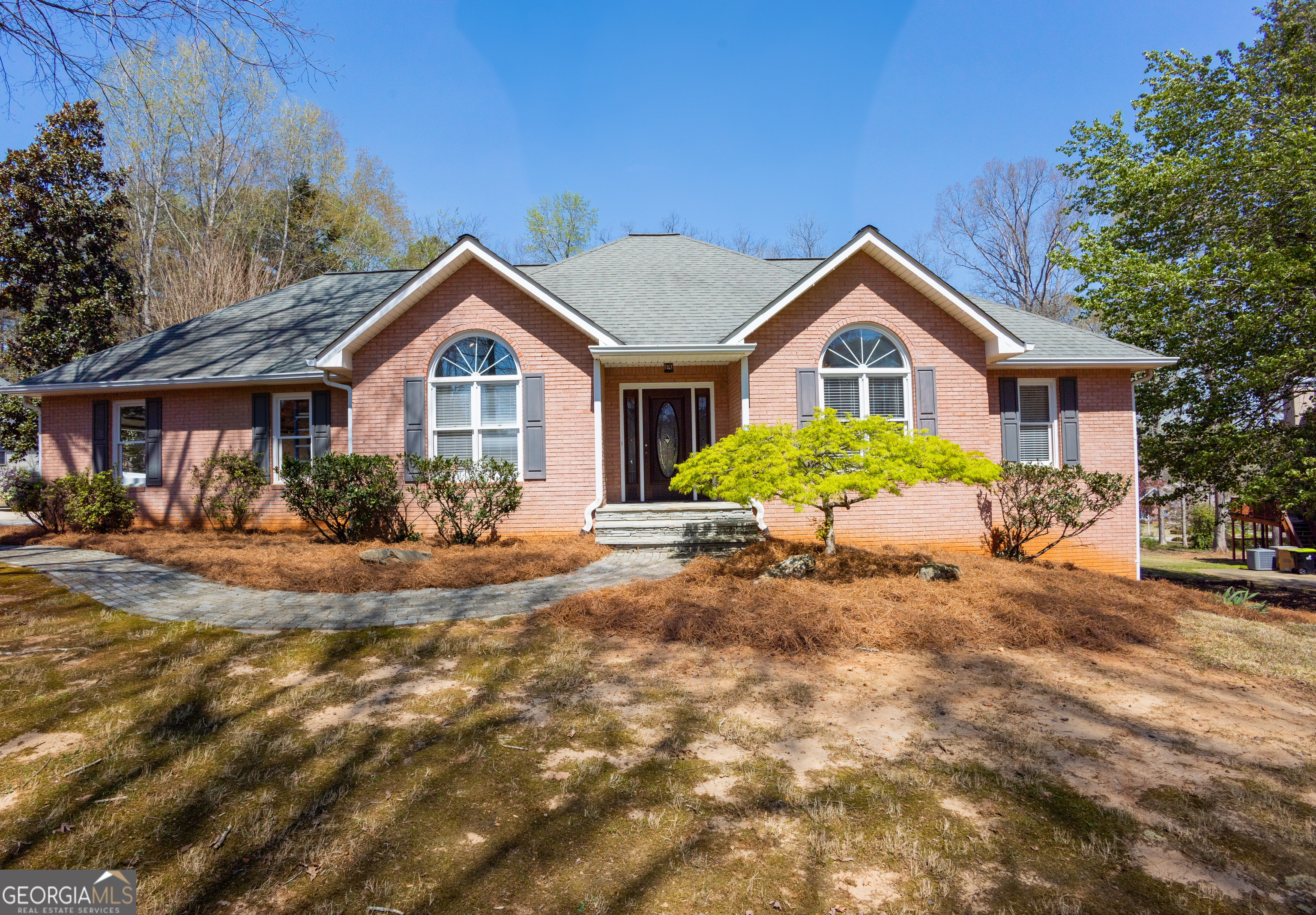 279 Windermere Circle Newnan, GA 30265 - Photo 1 of 1 a view of a yard in front of a house with large windows
