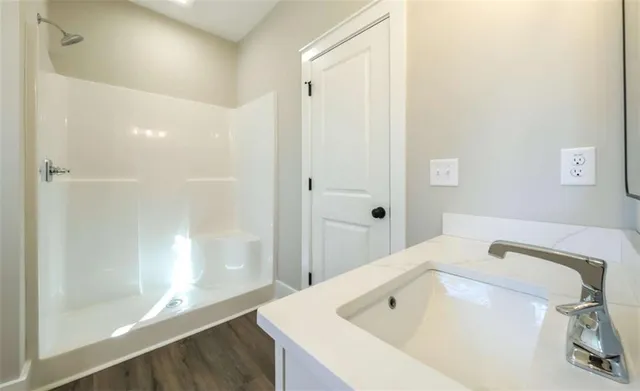 a bathroom with a tub sink and glass door