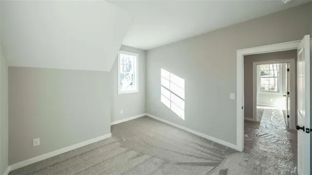 an empty room with windows and closet
