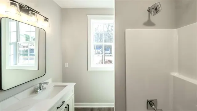 a bathroom with a sink a mirror and a window