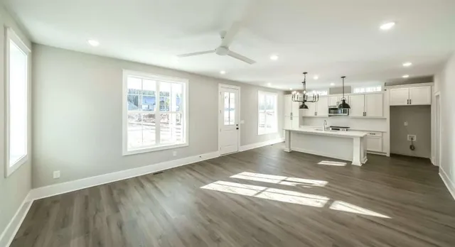 a view of kitchen with windows and refrigerator