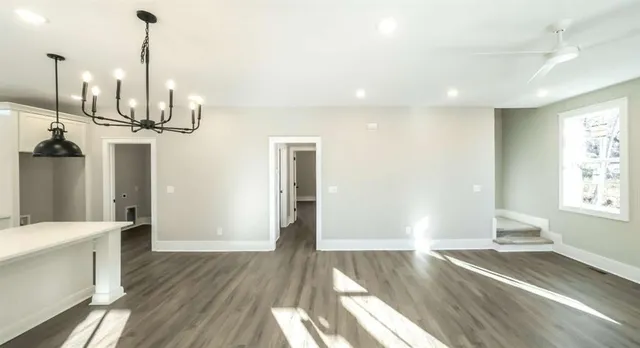 a view of a room with wooden floor and window