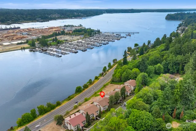 a living room with a bed and a large window