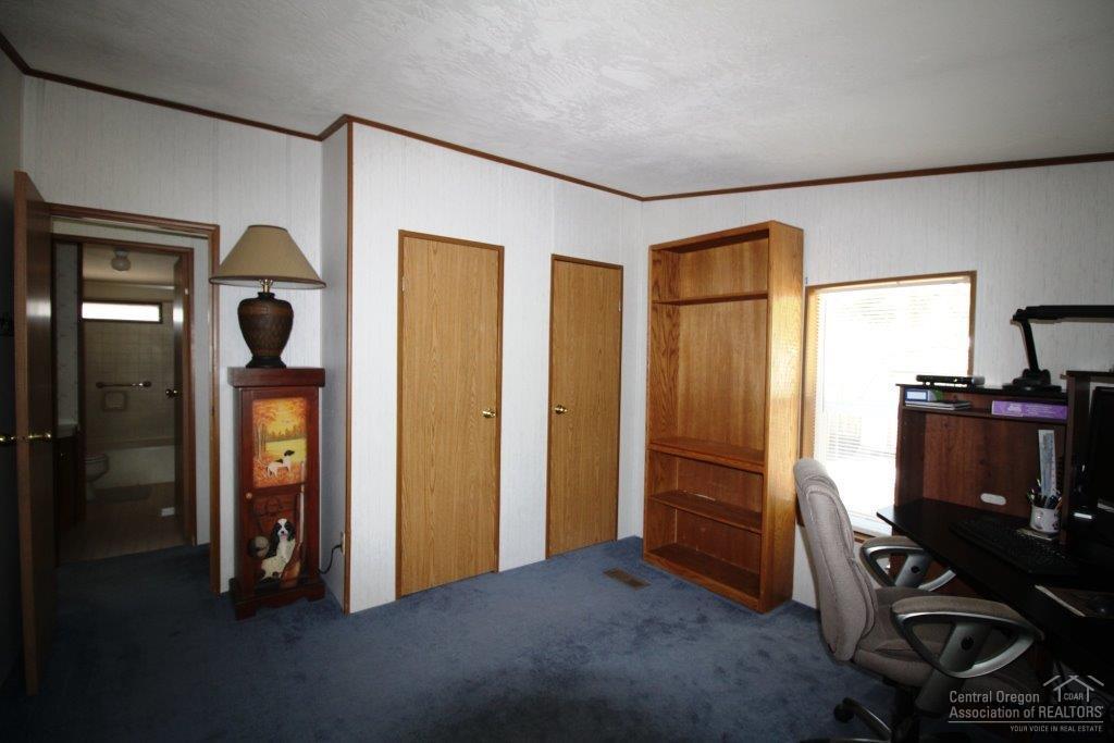 19235 Kiowa Road Bend, OR 97702 - Photo 11 of 25 a bedroom with a bed and a flat screen tv