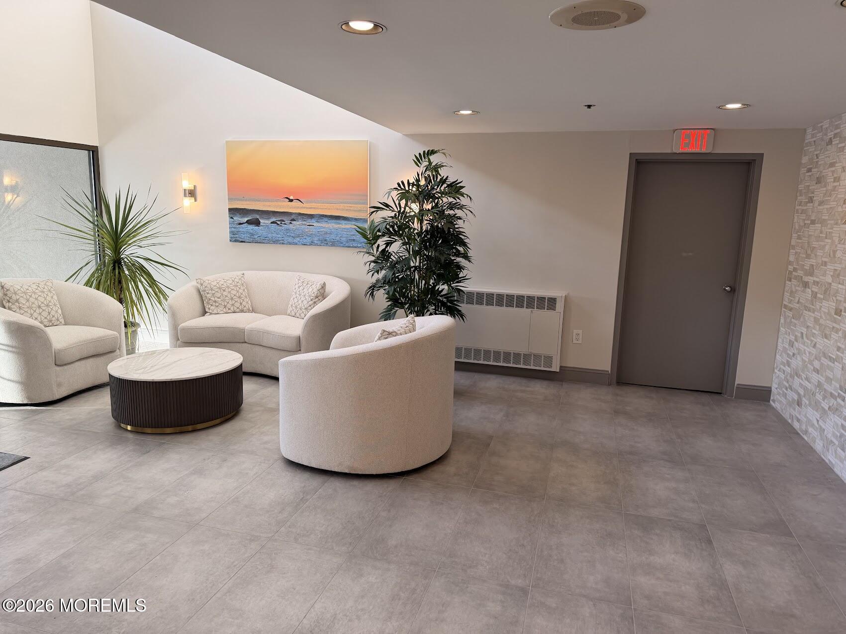 525 Ocean Boulevard, Unit 405 Long Branch, NJ 07740 - Photo 4 of 18 a living room with furniture and a potted plant