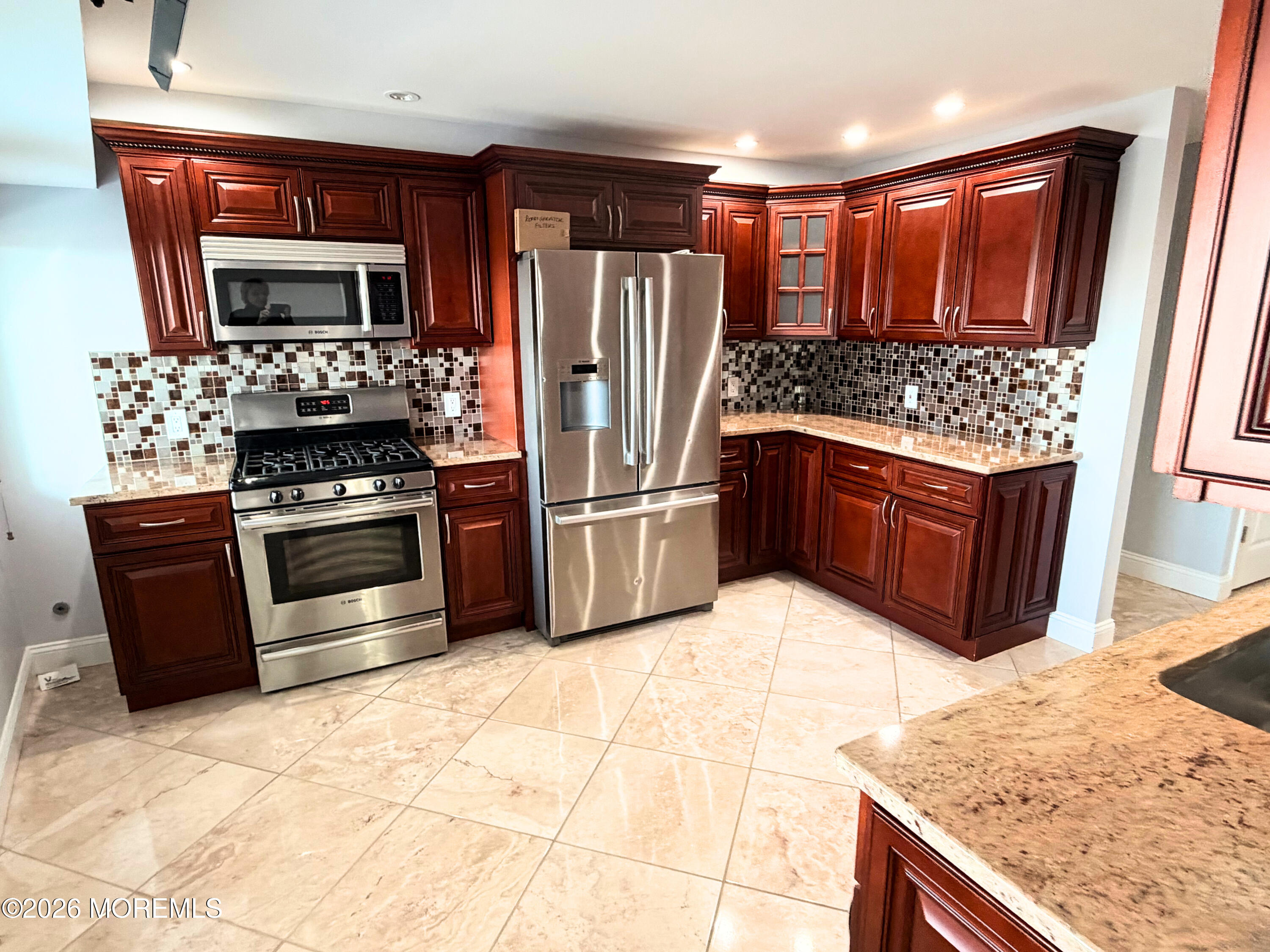 525 Ocean Boulevard, Unit 405 Long Branch, NJ 07740 - Photo 9 of 18 a kitchen with stainless steel appliances granite countertop a refrigerator oven a sink and dishwasher