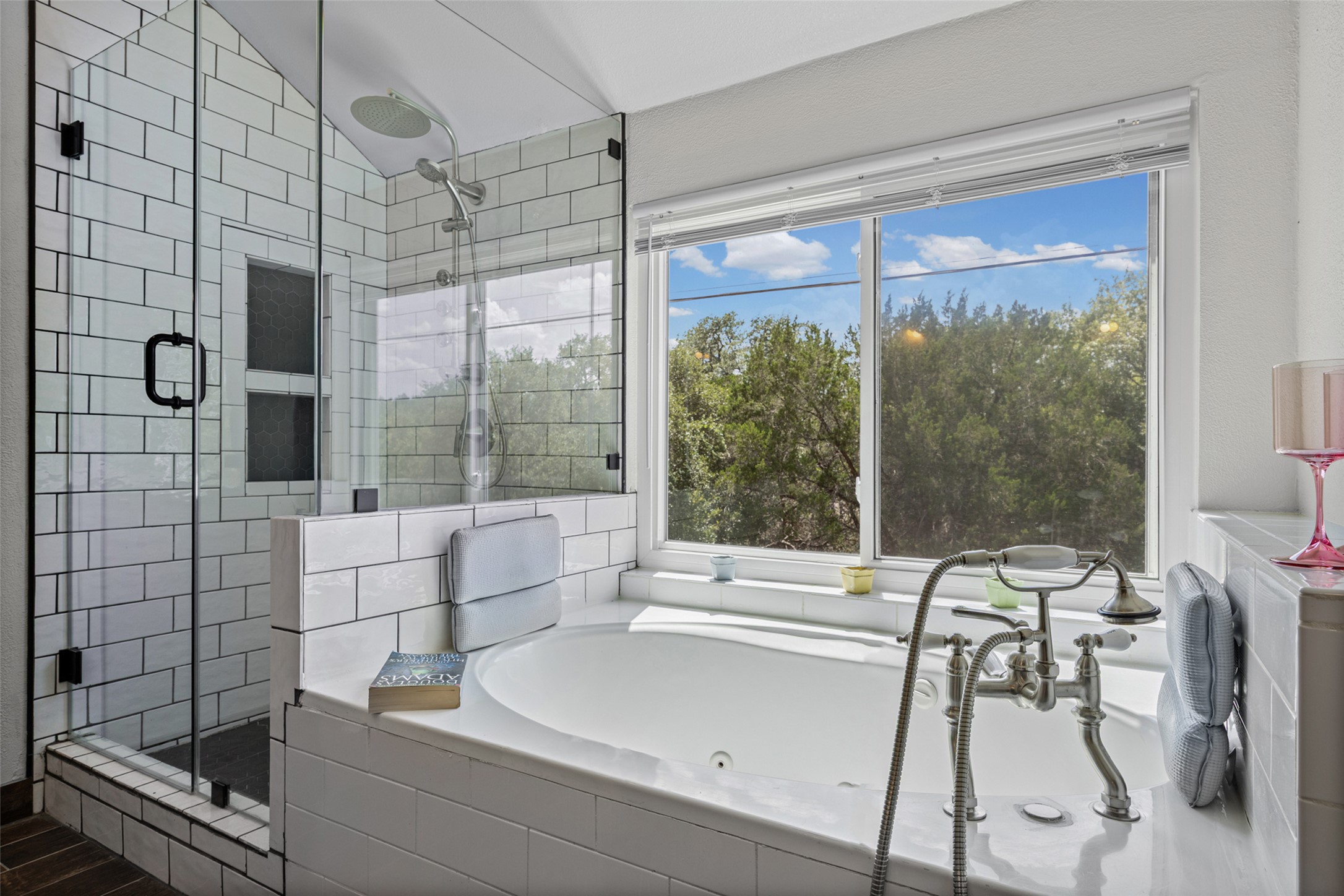 3011 Wadsworth Way Austin, TX 78748 - Photo 28 of 35 Luxuriate in the spacious tub with a beautiful outdoor view, alongside a modern glass-enclosed shower.