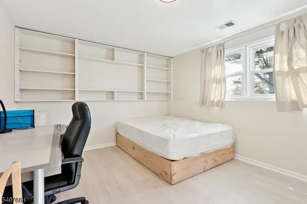 a bedroom with a bed a table and chair