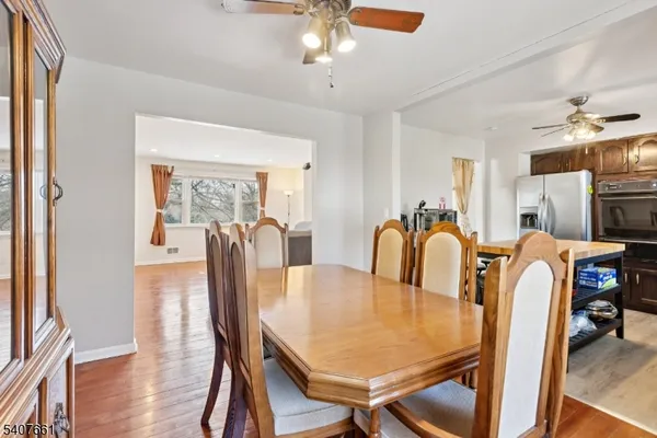 a dining room with furniture and wooden floor