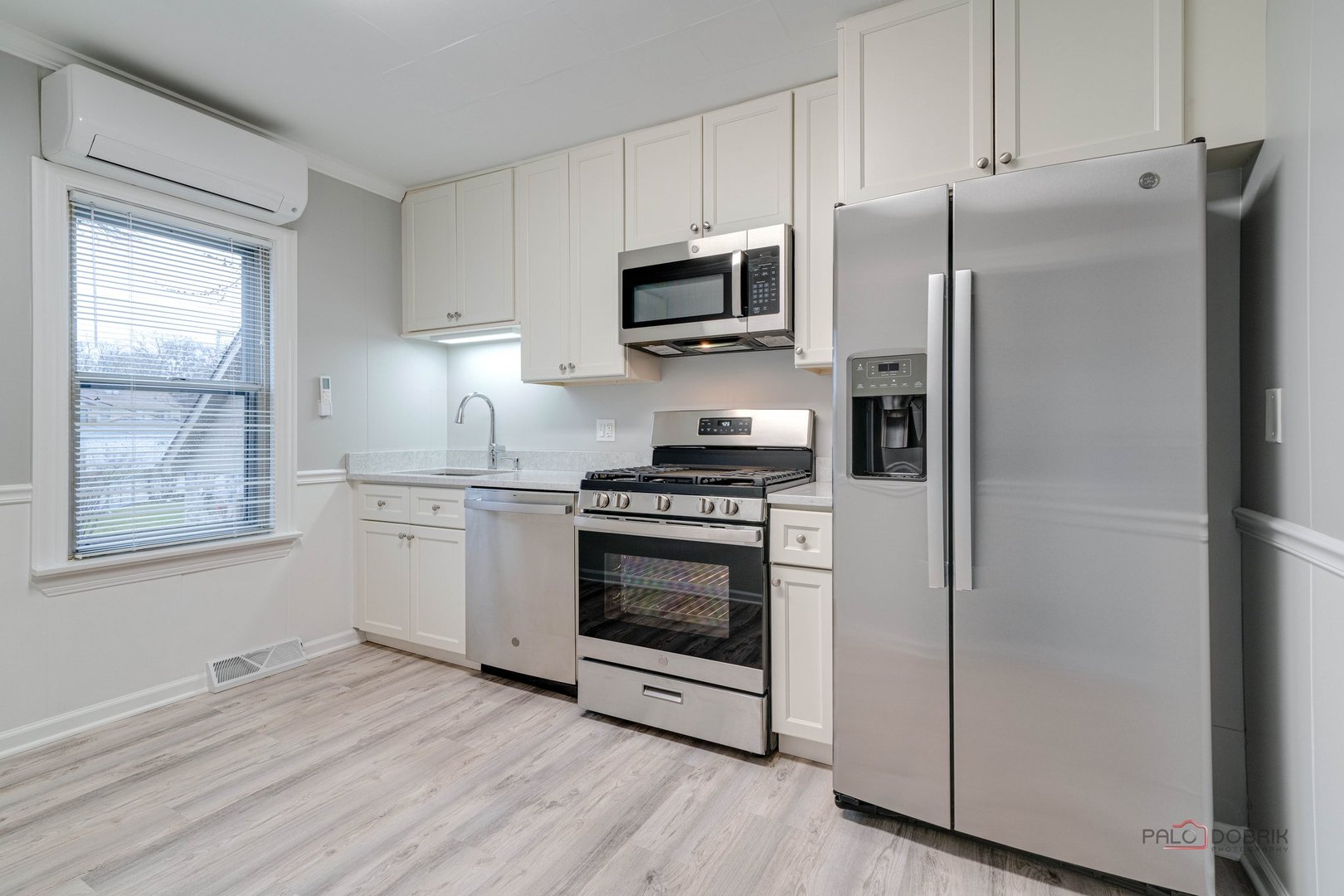 163 Eagle Point Road, Unit 2 Fox Lake, IL 60020 - Photo 13 of 38 a kitchen with granite countertop a refrigerator stove and microwave