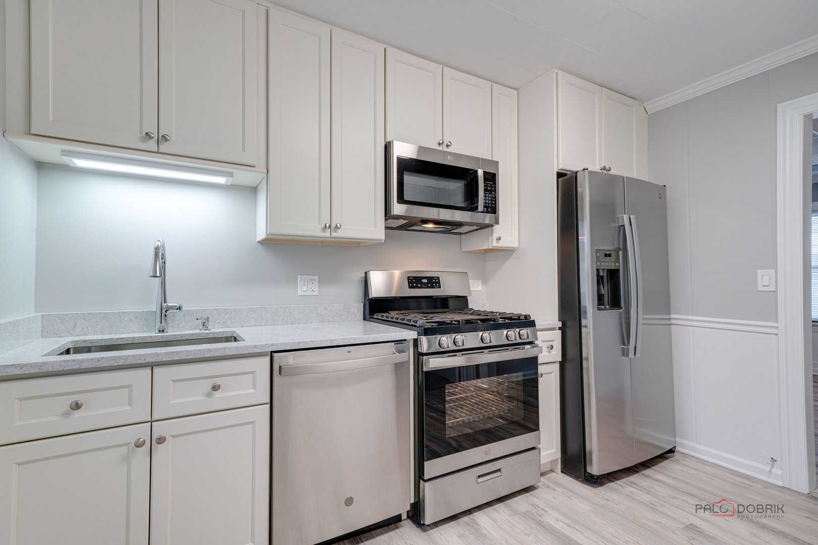 163 Eagle Point Road, Unit 2 Fox Lake, IL 60020 - Photo 14 of 38 a kitchen with stainless steel appliances granite countertop white cabinets and a stove top oven