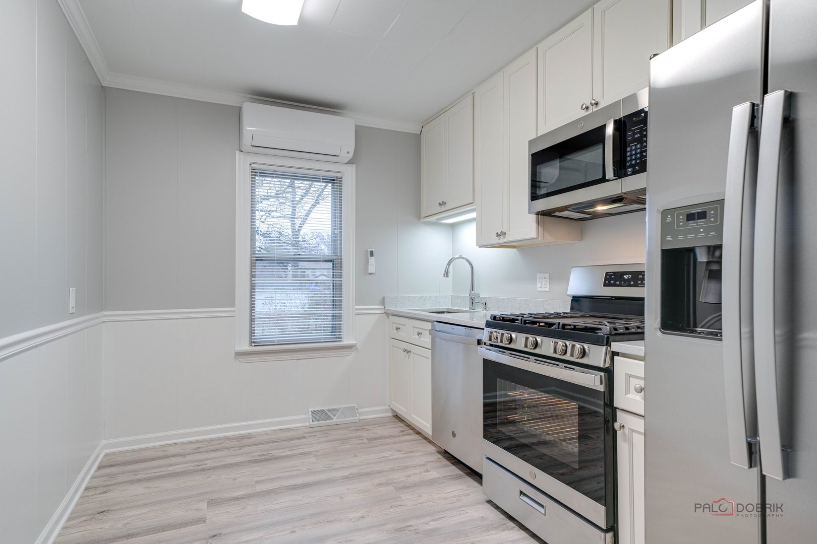 163 Eagle Point Road, Unit 2 Fox Lake, IL 60020 - Photo 16 of 38 a kitchen with stainless steel appliances a stove a microwave and cabinets