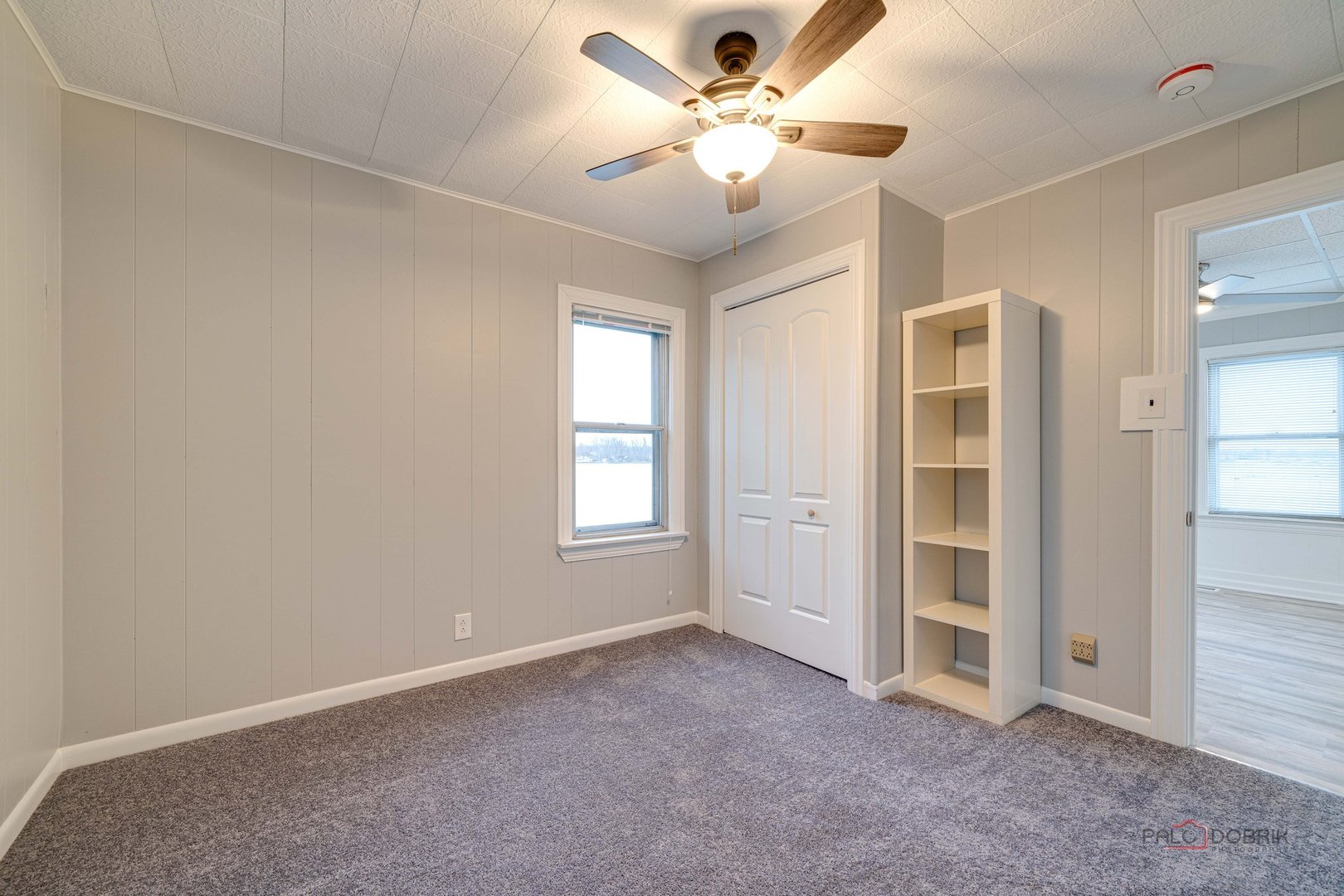 163 Eagle Point Road, Unit 2 Fox Lake, IL 60020 - Photo 18 of 38 an empty room with windows and fan
