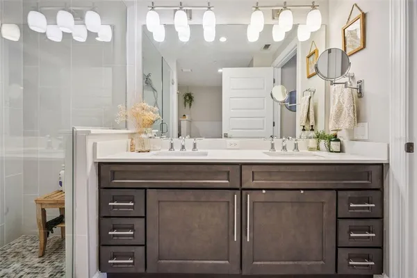 a bathroom with a sink vanity and a mirror