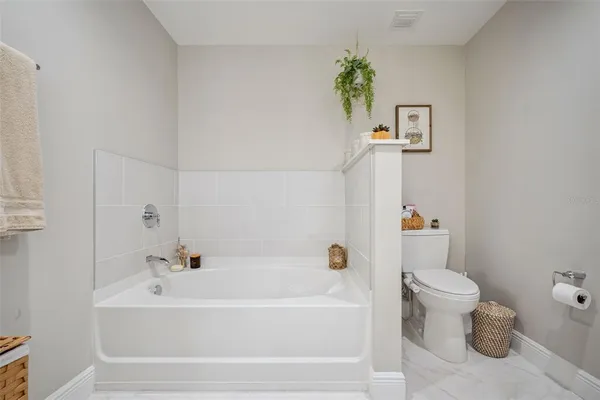 a white bath tub sitting next to a white toilet