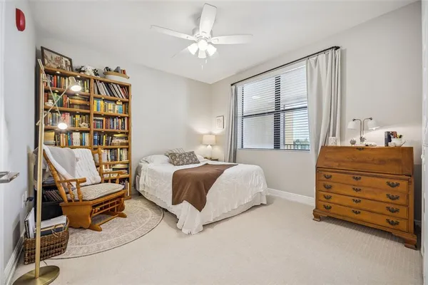a spacious bedroom with a bed and a chandelier