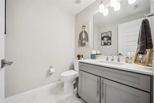 a bathroom with a sink a toilet and mirror
