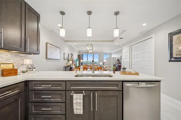 a kitchen with a sink stainless steel appliances a counter space and a window