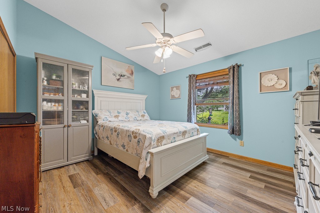808 Ryan Road, Unit 14 Medina, OH 44256 - Photo 20 of 40 Vaulted ceiling bedroom featuring wood-finish flooring and a ceiling fan with light fixture