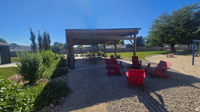 1500 Angel Street North, Unit 53 Layton, UT 84041 - Photo 18 of 20 Expansive outdoor living area featuring a covered pergola, a gravel patio, and a dedicated sand play area