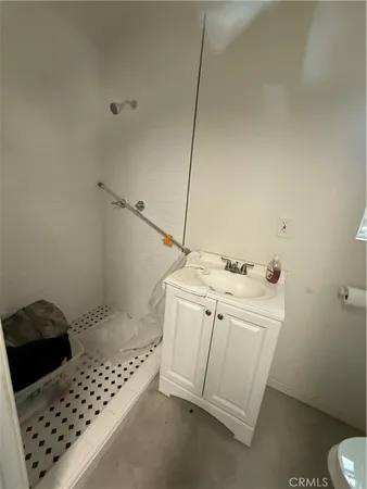 a bathroom with a granite countertop toilet a sink and a mirror