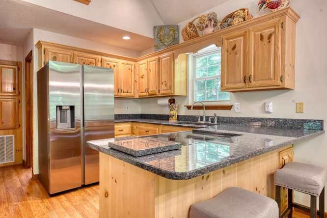 3333 Ellington Road Hayesville, NC 28904 - Photo 33 of 56 a kitchen with granite countertop a sink a counter top space cabinets and stainless steel appliances
