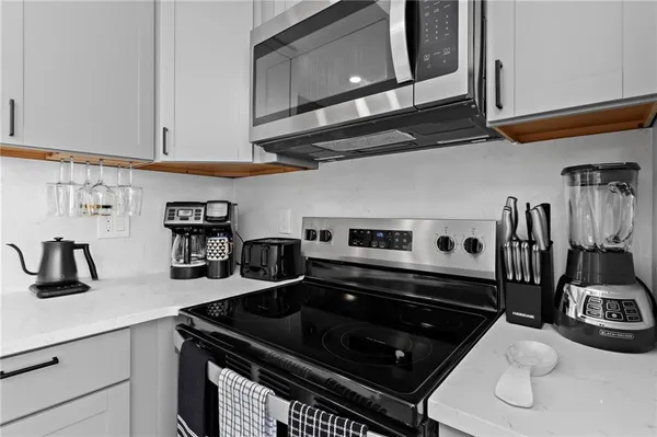 a kitchen with stainless steel appliances granite countertop a sink and stove