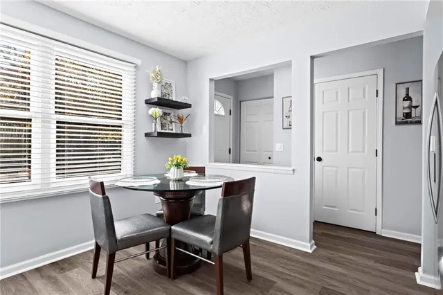 a view of a dining room with furniture and wooden floor