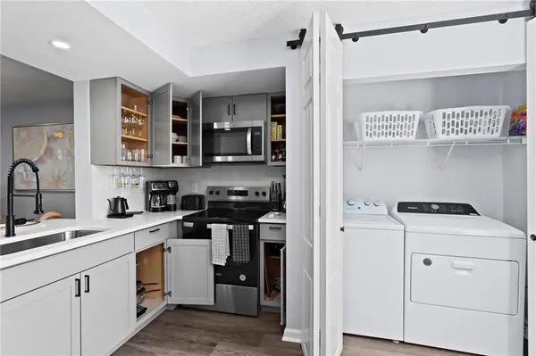 a kitchen with a sink a stove and cabinets
