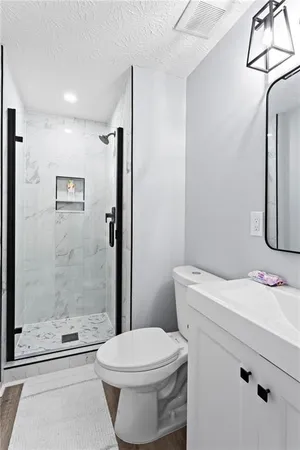 a bathroom with a sink toilet and shower