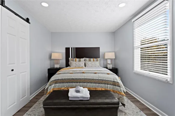 a bedroom with a bed and window