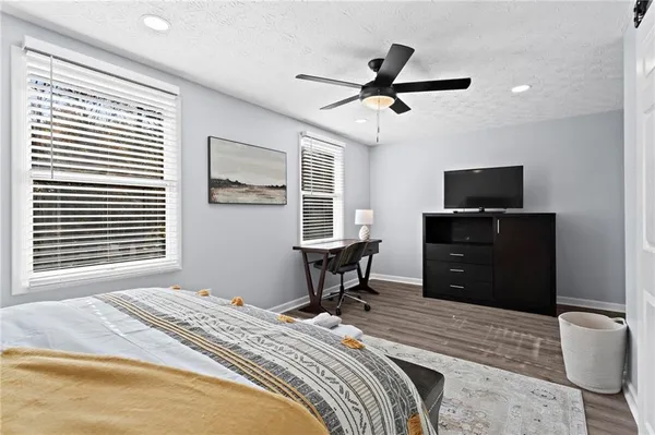 a bedroom with a bed and a television