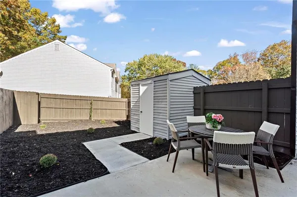 a backyard of a house with table and chairs
