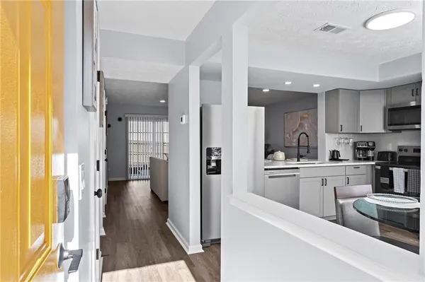a kitchen with cabinets and refrigerator