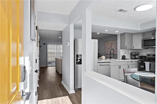 a kitchen with cabinets and refrigerator