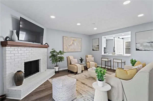 a living room with furniture a fireplace and a flat screen tv