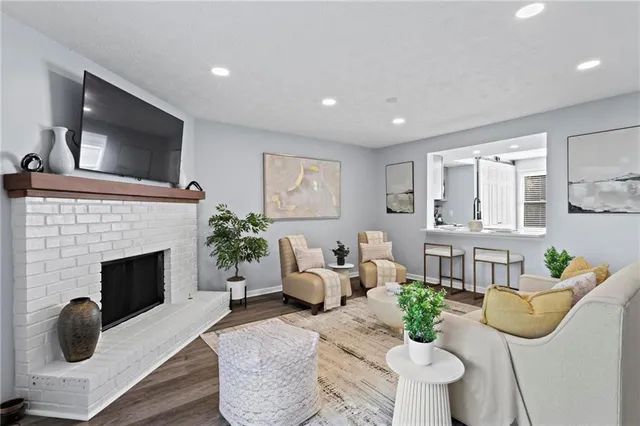 a living room with furniture a fireplace and a flat screen tv