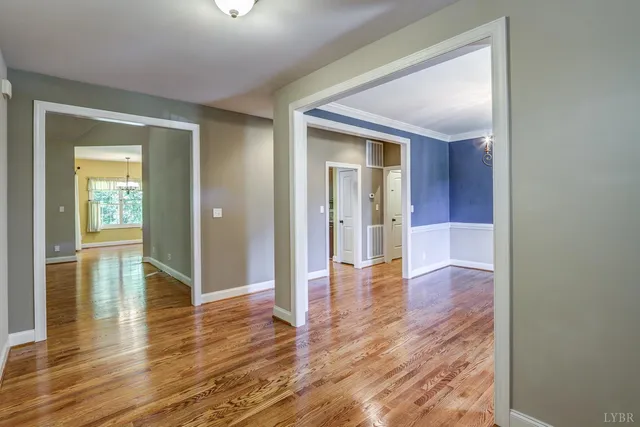 a living room with a fireplace and a wooden floor