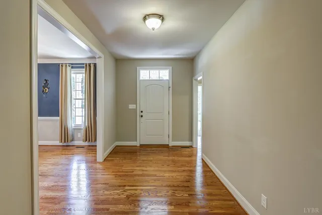 wooden floor fireplace and windows in an empty room